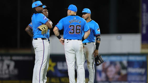 Mar 8, 2024; Jupiter, Florida, USA; Miami Marlins third baseman Jake Burger (36) talks to first baseman Josh Bell (9), shortstop Tim Anderson (7), and second baseman Luis Arraez (3) against the New York Mets during the fourth inning at Roger Dean Chevrolet Stadium. Mandatory Credit: Sam Navarro-USA TODAY Sports  